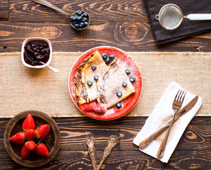 Fresh Strawberries Pancakes or Crepes with berries and chocolate