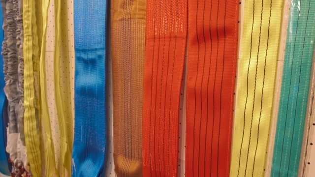 Rows of ropes from fabric of different colors for lifting heavy loads or towing vehicles. Shot in motion