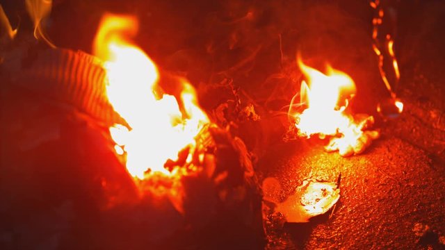 Extreme close up on open flame. Water douses it from the right. Slow motion.