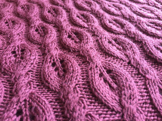 Beautiful crafted red violet color wool knitted background, natural soft surface