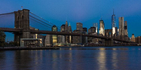 Fototapeta na wymiar OCTOBER 24, 2016 - BROOKLYN NEW YORK - Brooklyn Bridge and NYC skyline seen from Brooklyn at Sunset