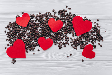 Valentine's Day. coffee beans,felt heart  on a wooden background