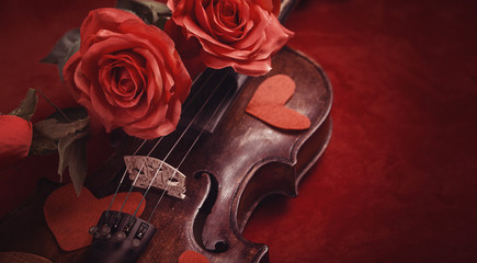 Valentine violin, red roses on dark red silk sheet, romantic instrument for valentine's day...