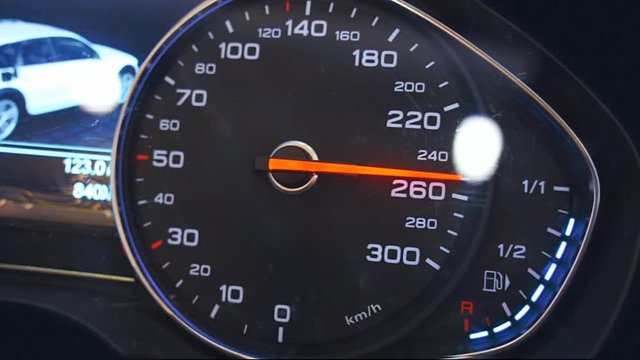 Car speedometer needle is rapidly approaching to the maximum value 300 km/h. Vehicle vibration adds adrenaline and increases the feeling of a strong acceleration