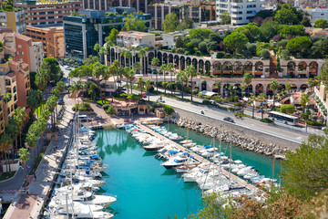 Monaco, Monte Carlo. View of the marina with luxury yachts and residential development