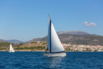 Fototapeta premium Luxury yachts in the regatta. Racing on a boats in the wind on the waves of the sea..