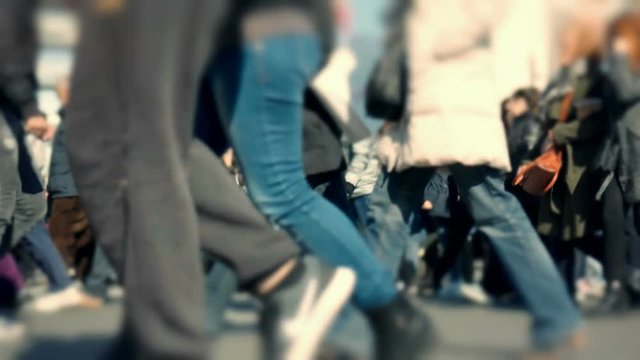 Big city crowd,anonymous people cross busy street slow motion 100p.Gimbal stabilized dolly shot of an anonymous crowd of pedestrians walking/crossing a busy city intersection.No logos or faces visible