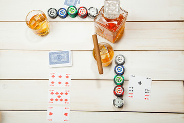 Naklejka na ściany i meble game of poker and a glass whiskey with ice on white wooden background