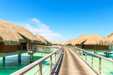 Traditional over water villas on a tropical lagoon of Bora Bora