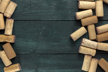Wine corks on dark wooden texture with copyspace