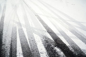 tire tracks on street after snow