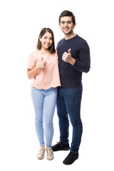 Attractive couple with thumbs up