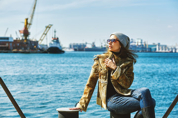 Fashionable girl in glasses on the background of the sea