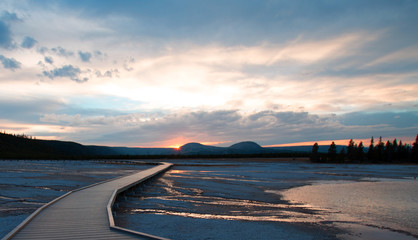 Sunset view of Walkway going by Turquoise Pool in the Midway Geyser Basin in Yellowstone National Park USA