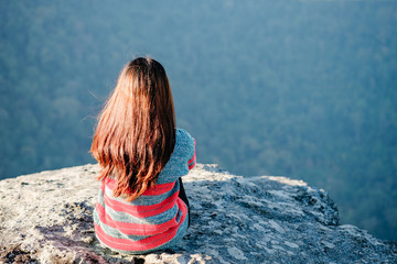 asian girl sitting alone  at mountain