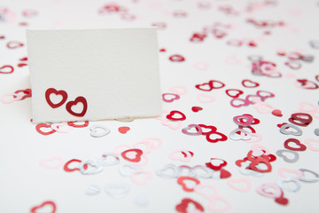 Greeting card on a white background with colorful hearts confetti. Valentines day concept