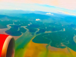 Fototapeta na wymiar The sea view from airplane porthole window