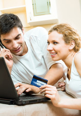 couple with laptop, paying by credit card in internet