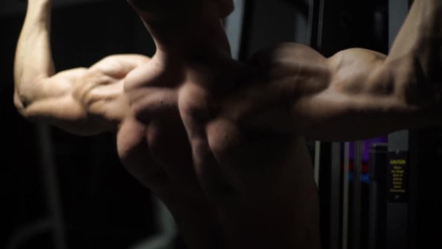 Muscular bodybuilder handsome men doing exercises in gym naked torso