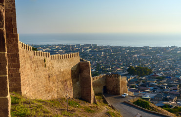 Fototapeta na wymiar Wall of Naryn-Kala fortress and view of Derbent city.