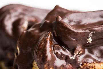 Chocolate eclair on the white table. Shallow depth of field.