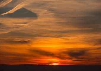 Fiery sunset from Bergamo city to the Padana valley. Lombardy, Italy. Sunset during fall season.