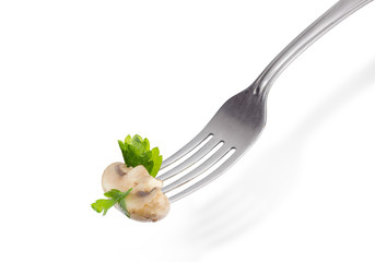 Half of the fried button mushroom on the fork closeup