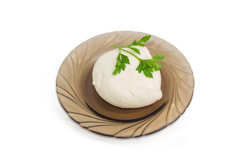 Mozzarella cheese with parsley twig on a glass saucer
