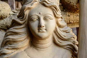 Fototapeta na wymiar Unfinished clay idol of Hindu Goddess.