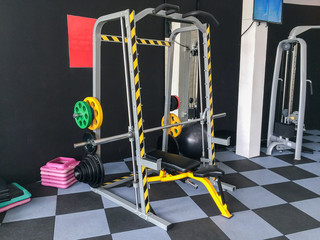 Smith machine - weight machine for weight training in gym consisting of steel rails and barbell