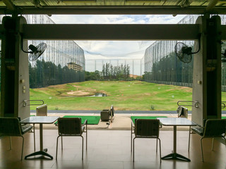 Golf driving range, golf green and sand bunker with distance measure in low key