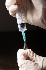 Syringe and vial in hands