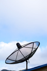 Radio telescope installed on roof with clear sky background