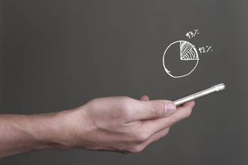 Hand holding smart phone with growing up multimedia icons