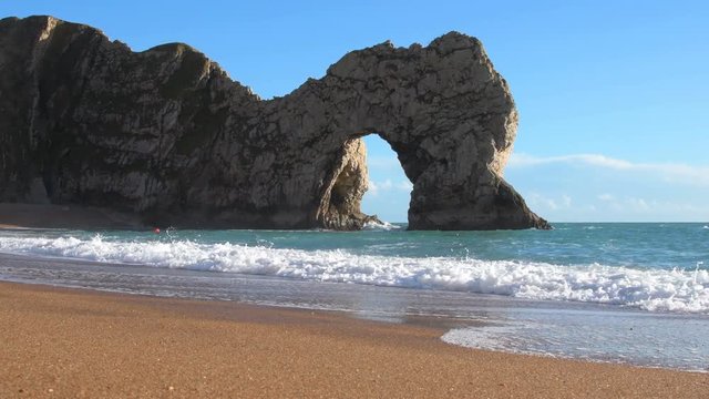 Beach by Durdle Door on the Jurassic Coast of Dorset, UK. Famous landmark.