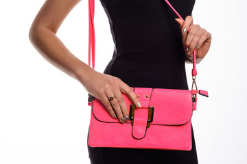 Girl with pink bag in her hand close-up
