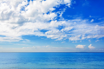 Naklejka na ściany i meble Blue sea and a moving reflection of sunlight