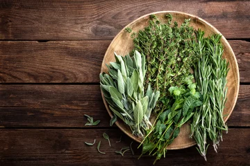 Wall murals Aromatic various fresh herbs, rosemary, thyme, mint and sage on wooden background