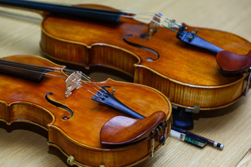 Two old broken violins isolated