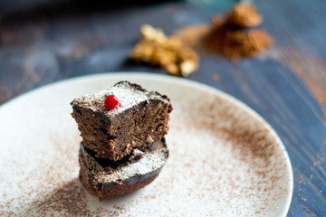 brown cake with cranberry on the white plate