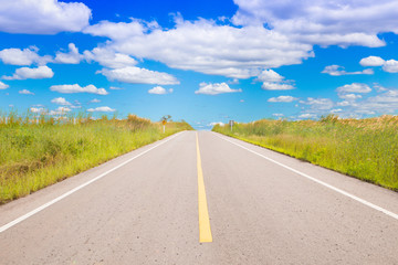 Empty countryside road and sunbeam sky background.