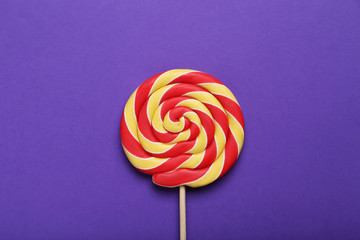 Sweet lollipop on purple background