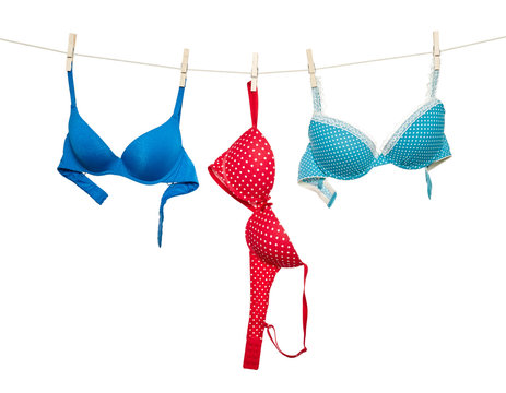 Female color bra hanging on rope