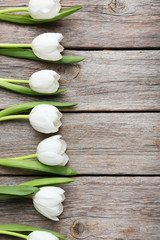 Fototapeta na wymiar Bouquet of tulips on a grey wooden table