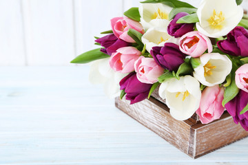 Bouquet of tulips on a white wooden table