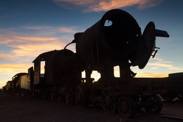 Fototapeta na wymiar Ancient train cemetery at sunset