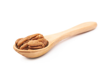 Spoon of pecan nuts isolated
