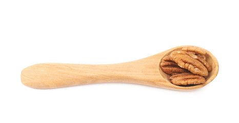 Spoon of pecan nuts isolated