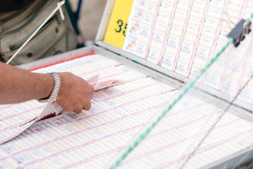 Man buying lottery at the counter. Thai lottery offers a form of