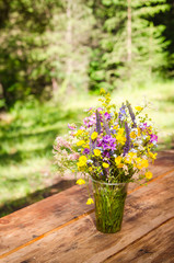 beautiful bouquet of bright wildflowers on a wooden table
